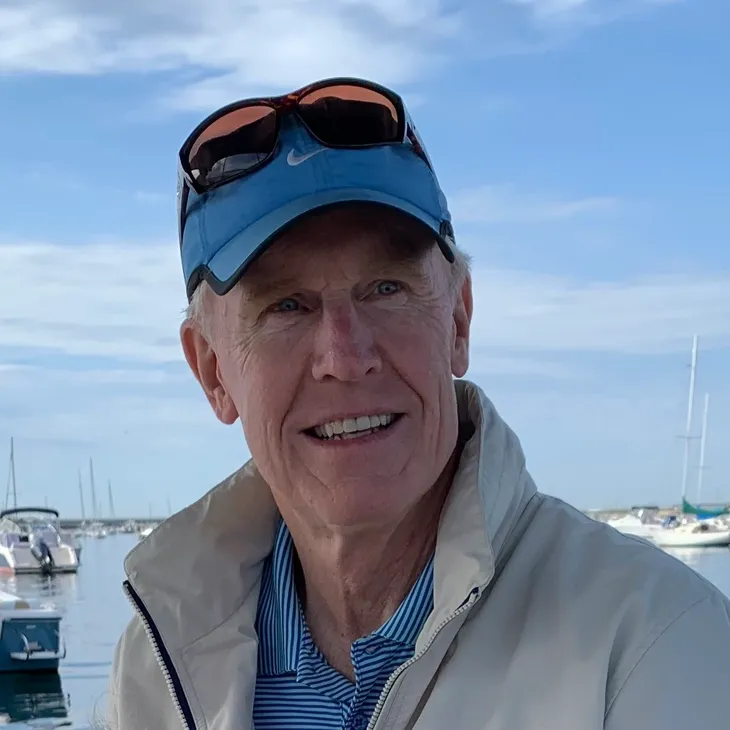 Smiling senior man with sunglasses at marina